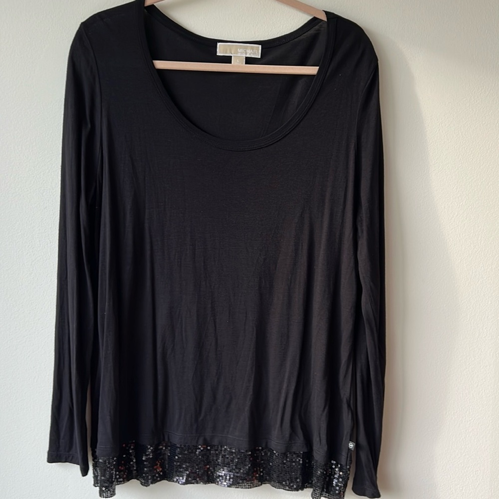Micheal Kors black top with black sequin bottom trim. Size L